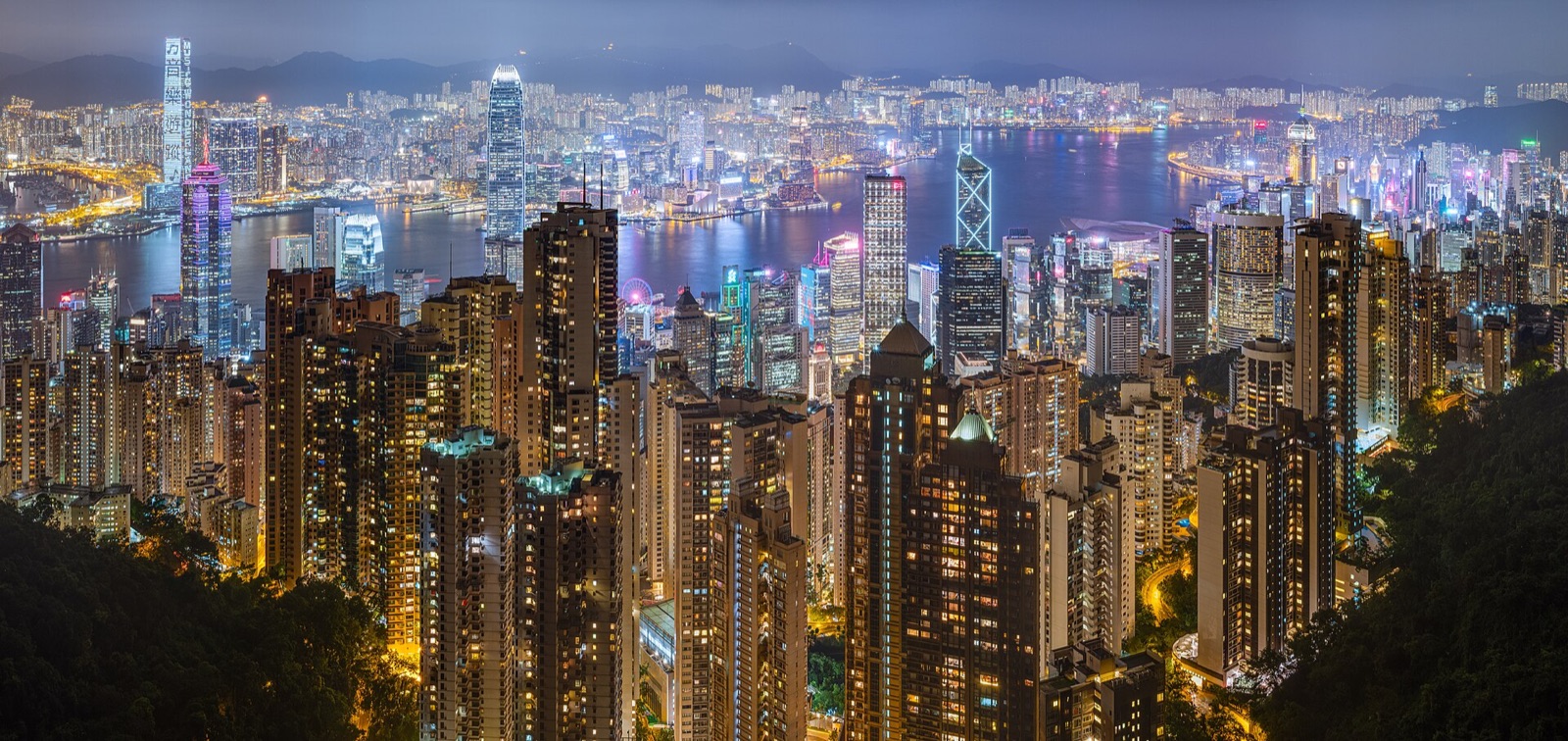 Victoria Harbour and the Hong Kong skyline illuminated at night